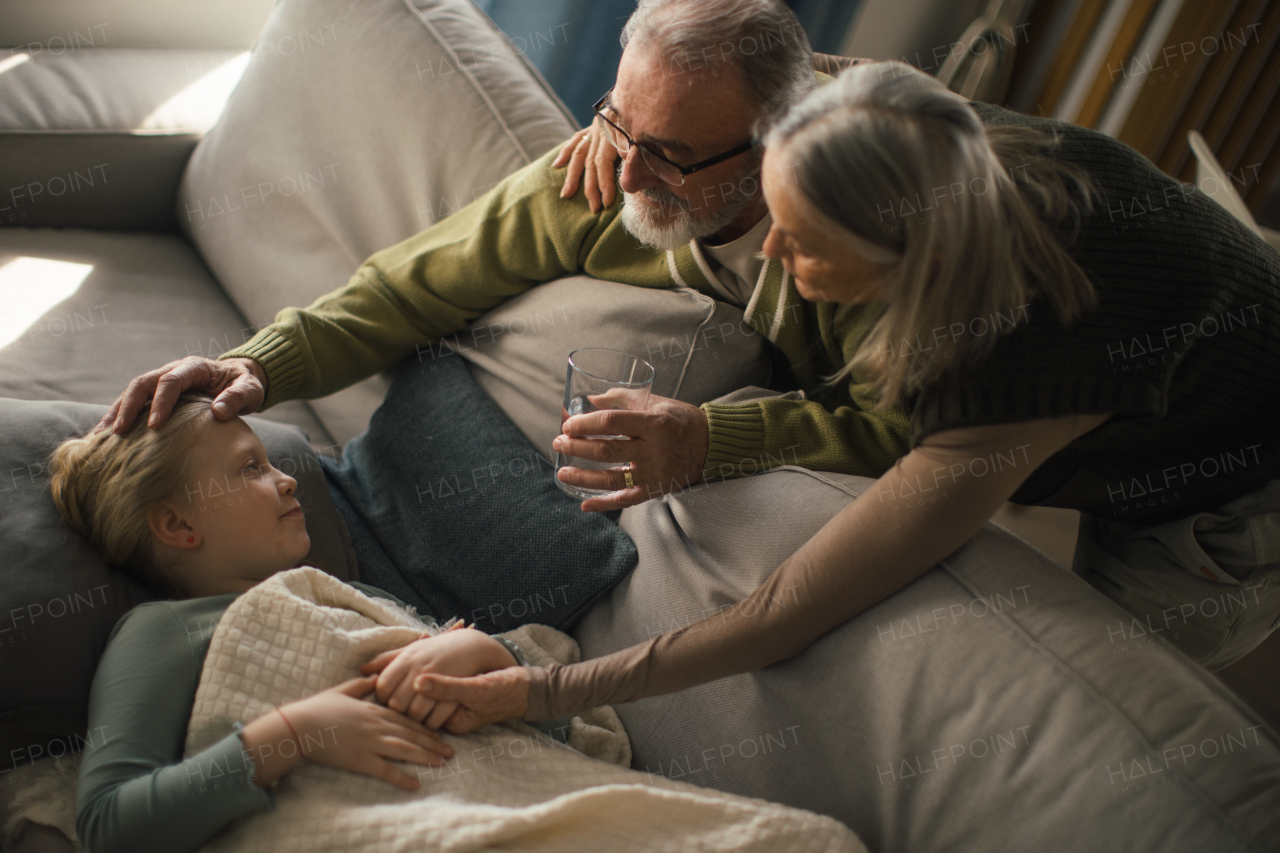 Grandparents taking care of little sick granddaughter.