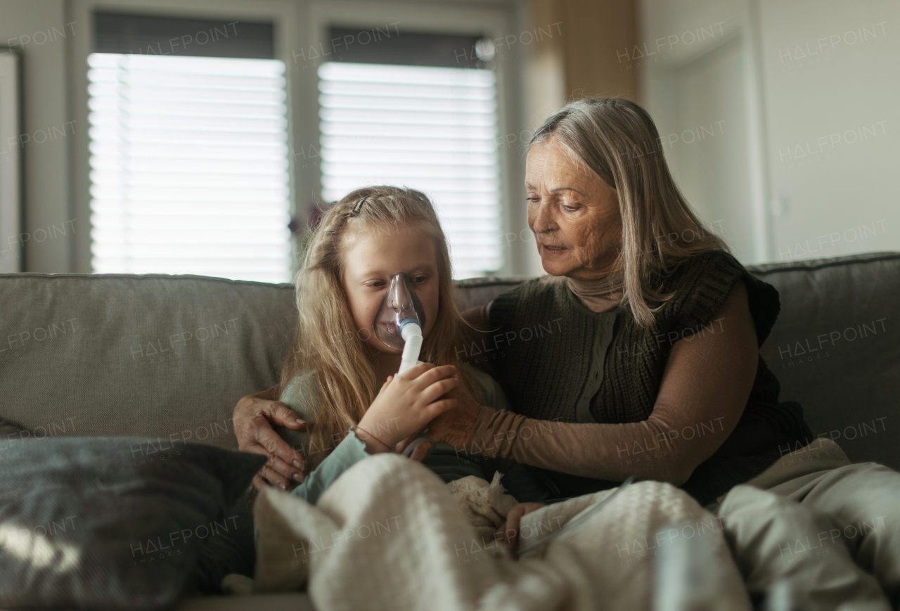 Senior woman taking care of sick granddaughter.