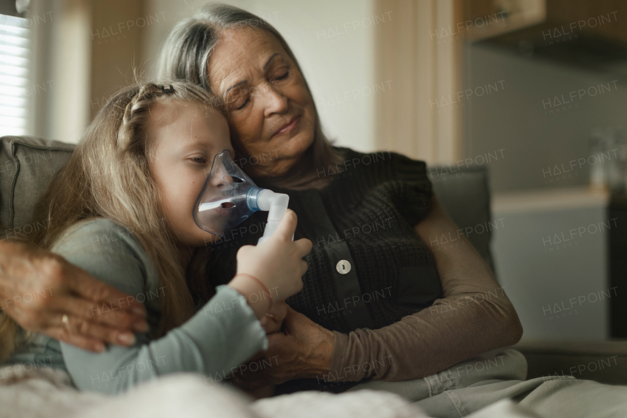 Senior woman taking care of sick granddaughter.