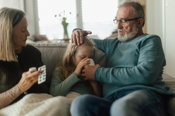 Grandparents taking care of little sick granddaughter.