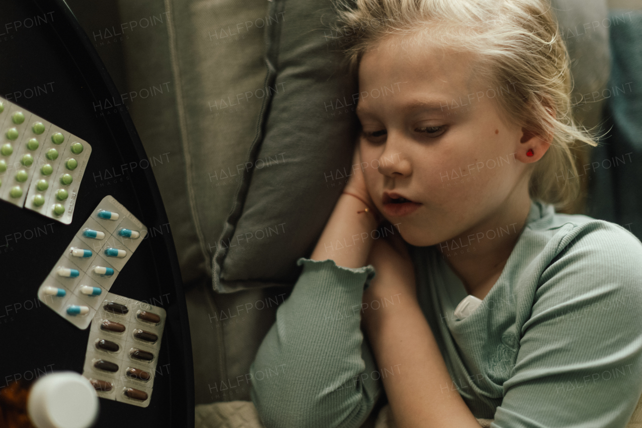 LIttle sick girl lying and sleeping in the bed.