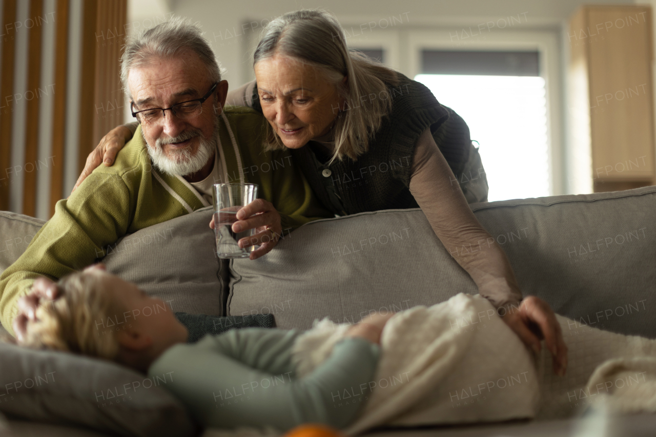 Grandparents taking care of little sick granddaughter.