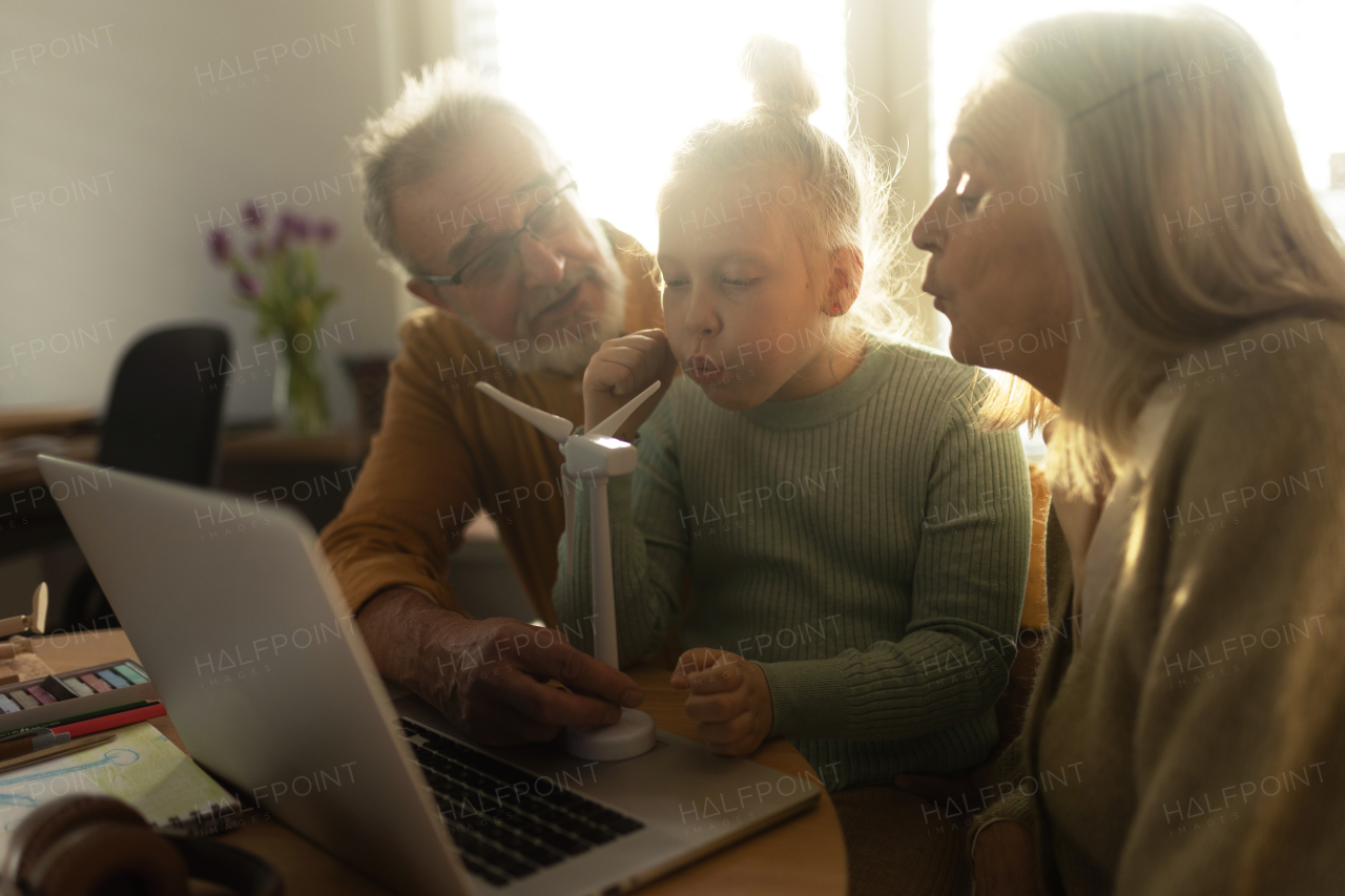 Senior couple studying with their granddaughter.