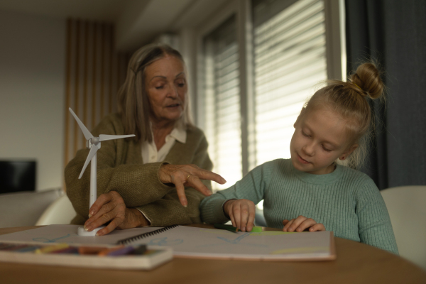 Senior man studying with his granddaughter.