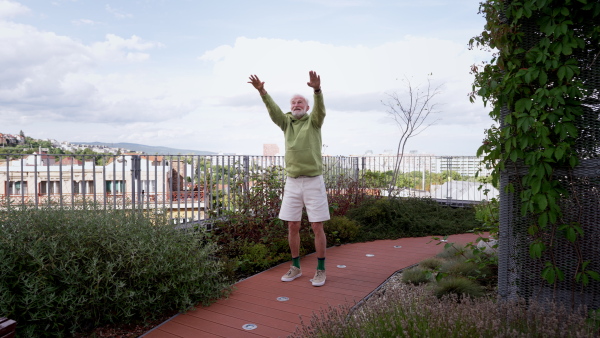 Senior man exercising outdoors in the city. An older, vital man leads an active lifestyle, going for a run every day.