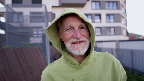 Senior man exercising outdoors in the city. An older, vital man leads an active lifestyle, going for a run every day.