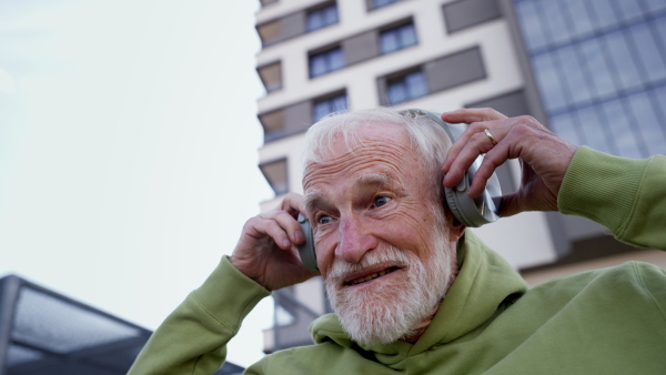 Senior man exercising outdoors in the city. An older, vital man leads an active lifestyle, going for a run every day.