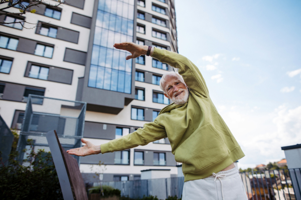 Senior man exercising outdoors in the city. An older, vital man leads an active lifestyle, going for a run every day.