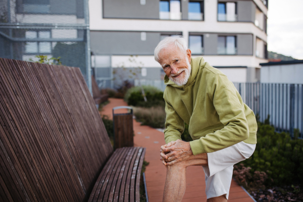 Senior man exercising outdoors in the city. An older, vital man leads an active lifestyle, going for a run every day.