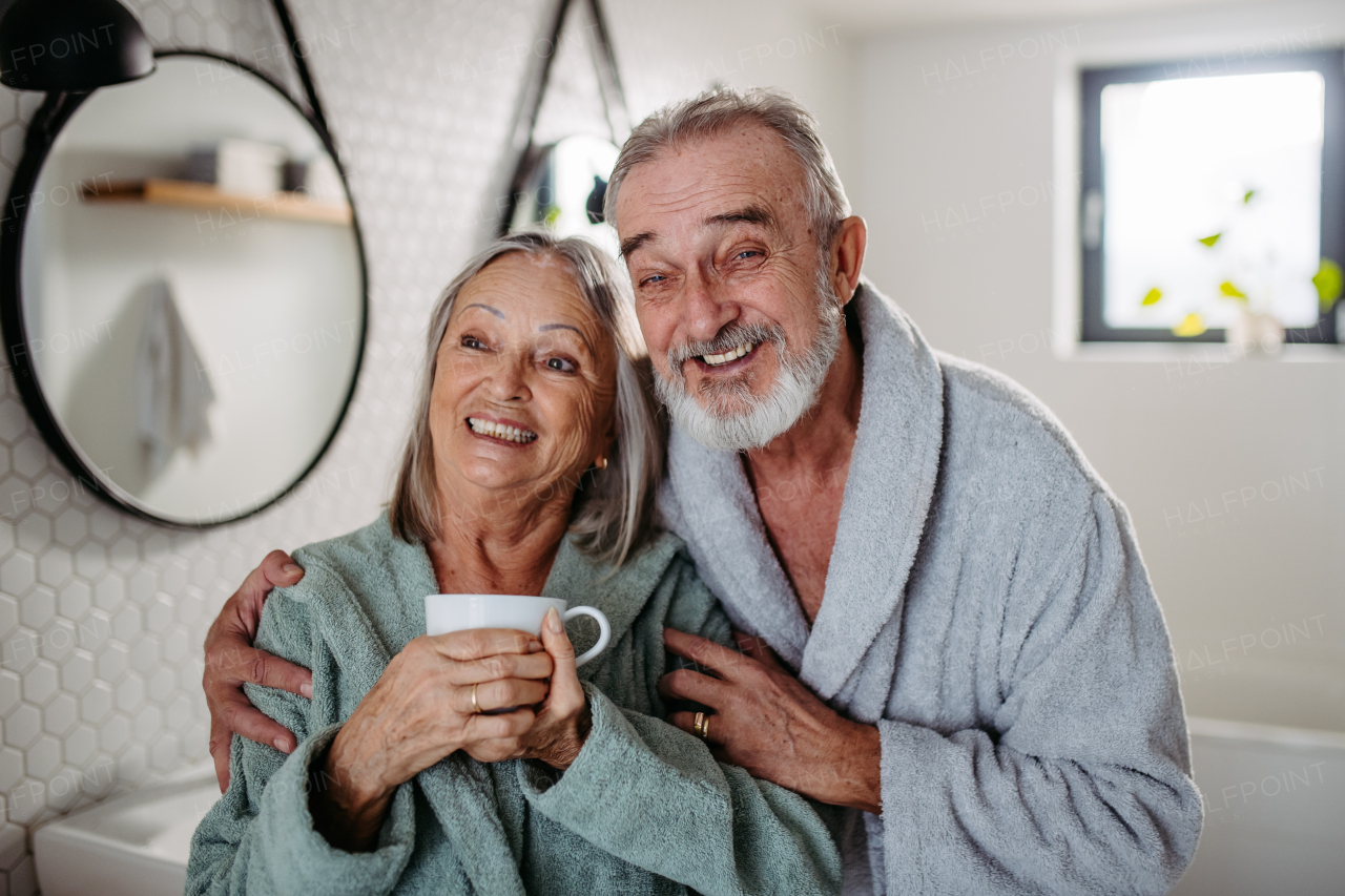 Senior couple having morning routine in the bathroom. Eldery husband and wife in love.