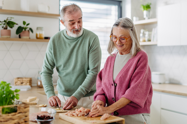 Senior couple cooking together in the kitchen.