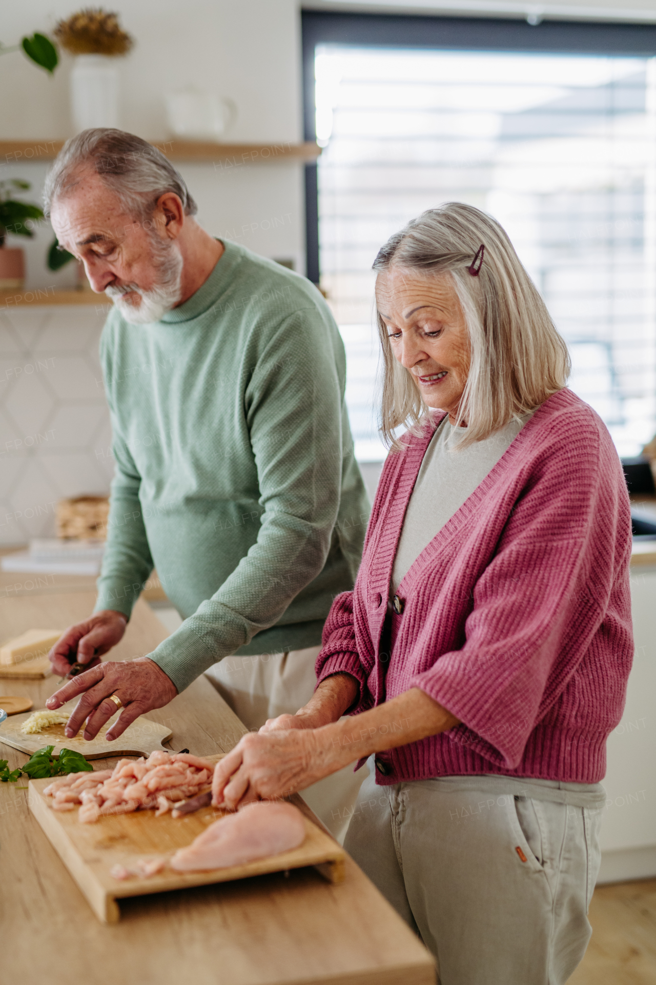 Senior couple cooking together in the kitchen.