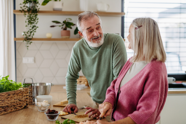 Senior couple cooking together in the kitchen.