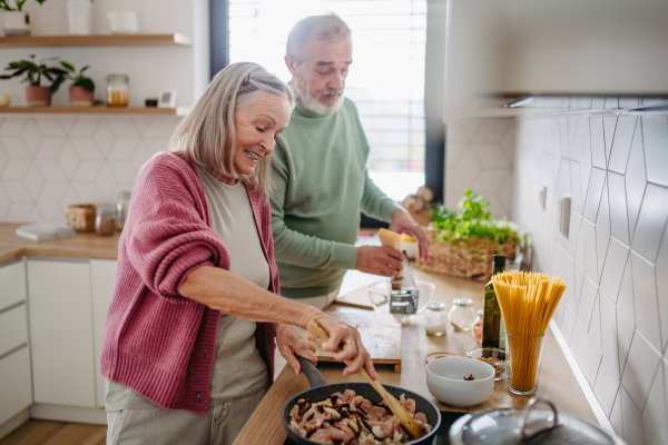 Senior couple cooking together in the kitchen.