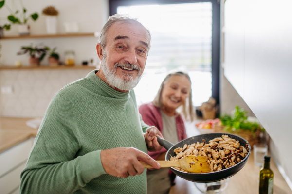 Senior couple cooking together in the kitchen.