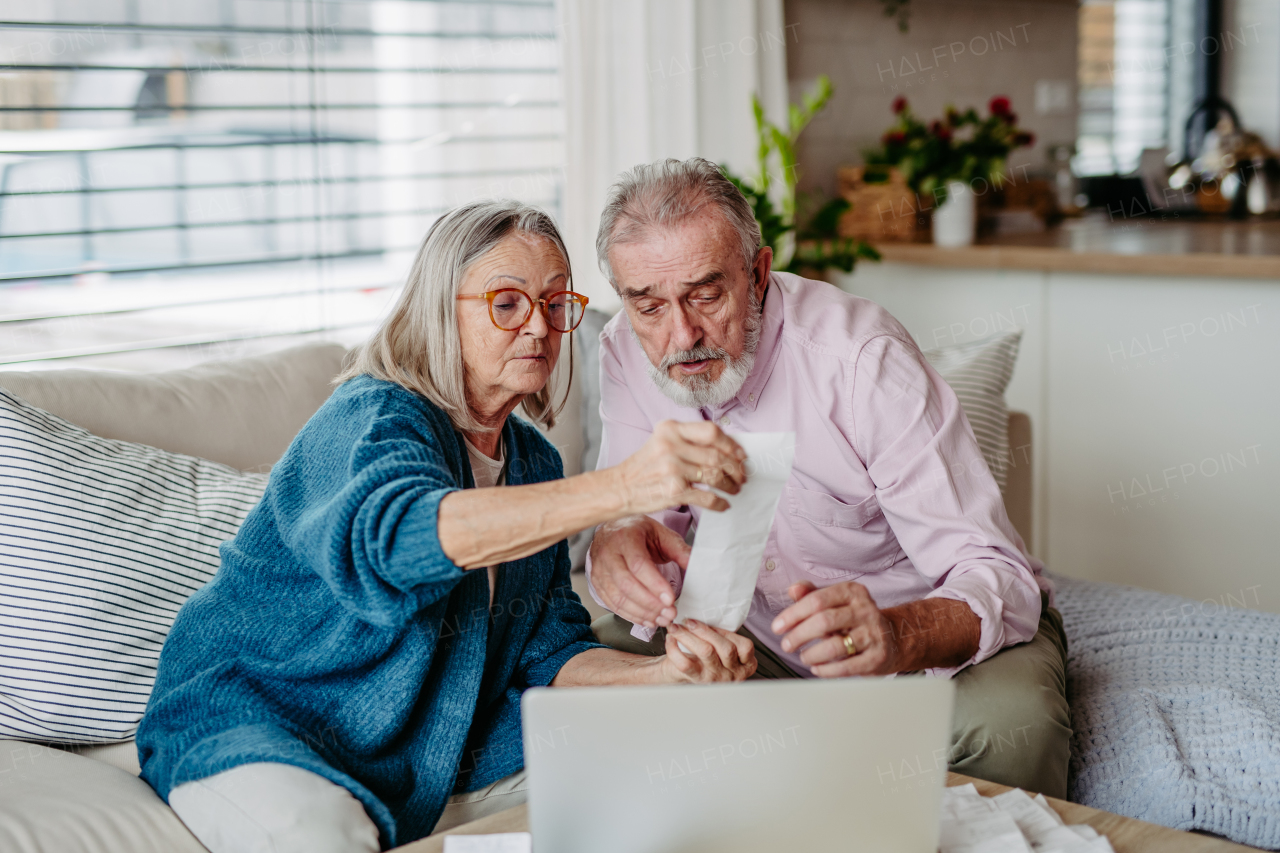 Senior couple checking their bills, concept of finance.