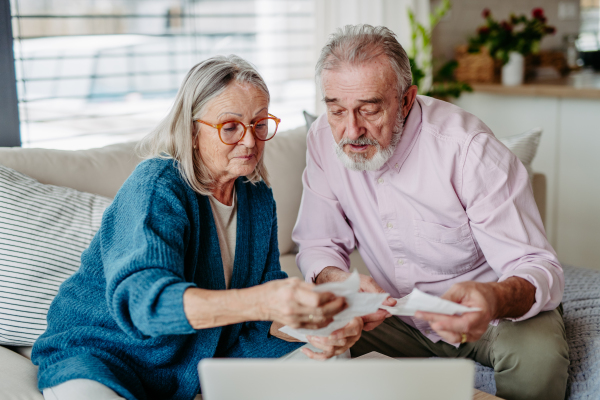 Senior couple checking their bills, concept of finance.