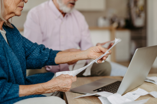 Senior couple checking their bills, concept of finance.