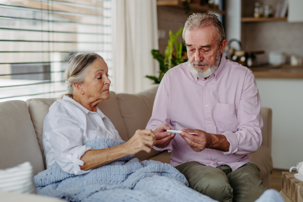 Senior man taking care of his wife. with flu