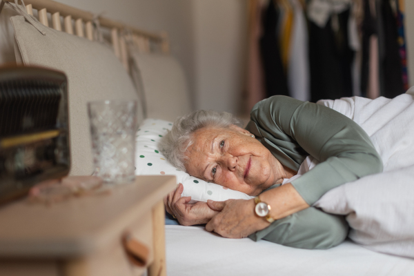 Senior woman sleeping in her bed alone. Loneliness and social isolation of eldery woman.