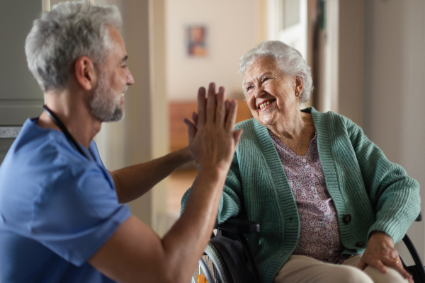 Caregiver spending time with his senior woman client.