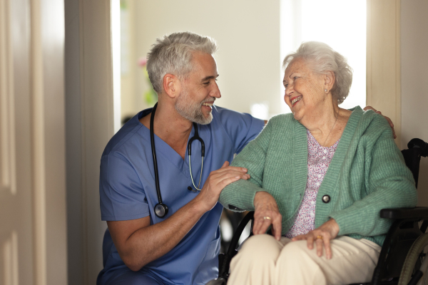 Caregiver doing regular check-up of senior client in her home.