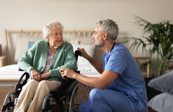 Caregiver doing regular check-up of senior client in her home.