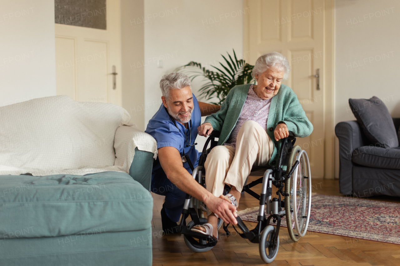 Caregiver doing regular check-up of senior client in her home.