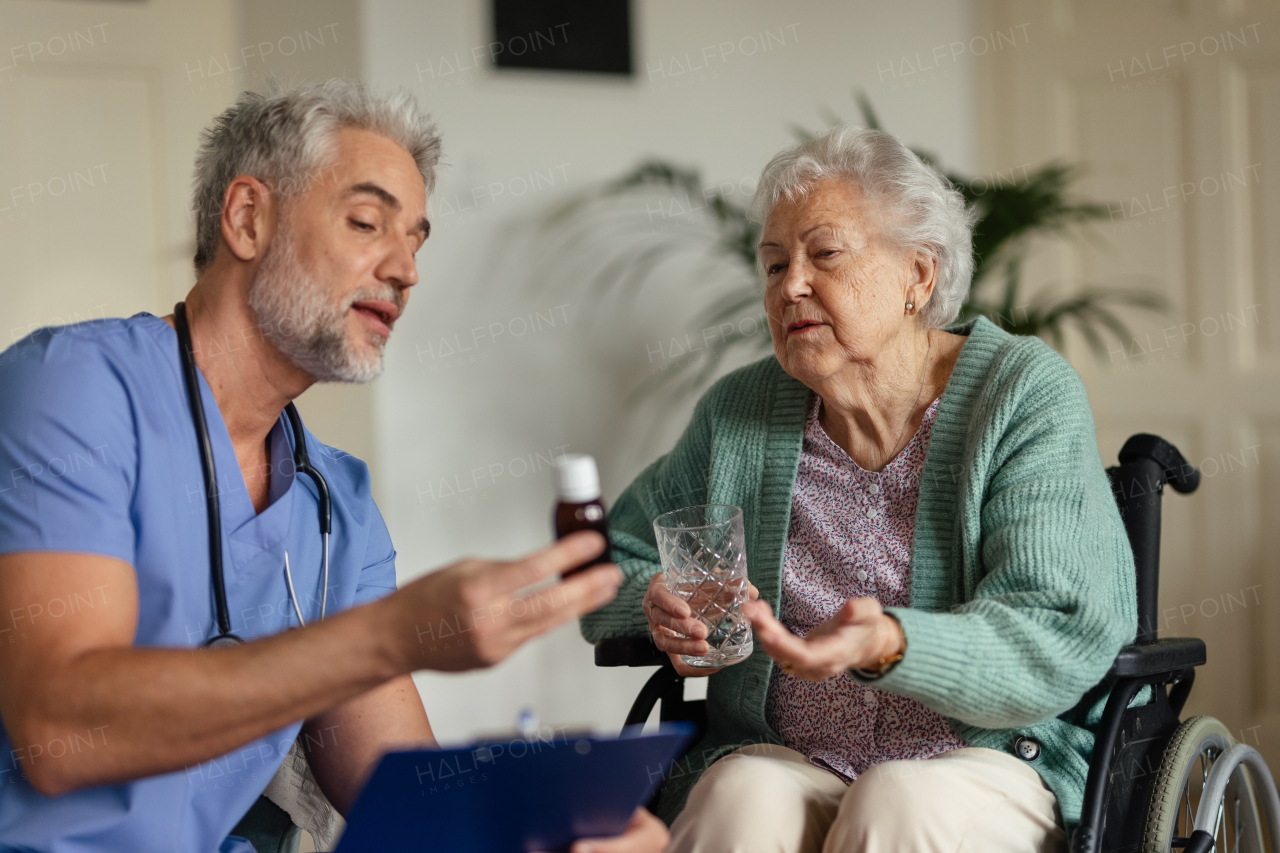 Caregiver doing regular check-up of senior client in her home.