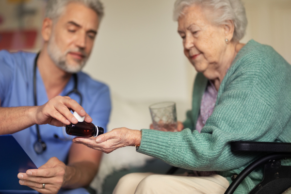 Caregiver doing regular check-up of senior client in her home.