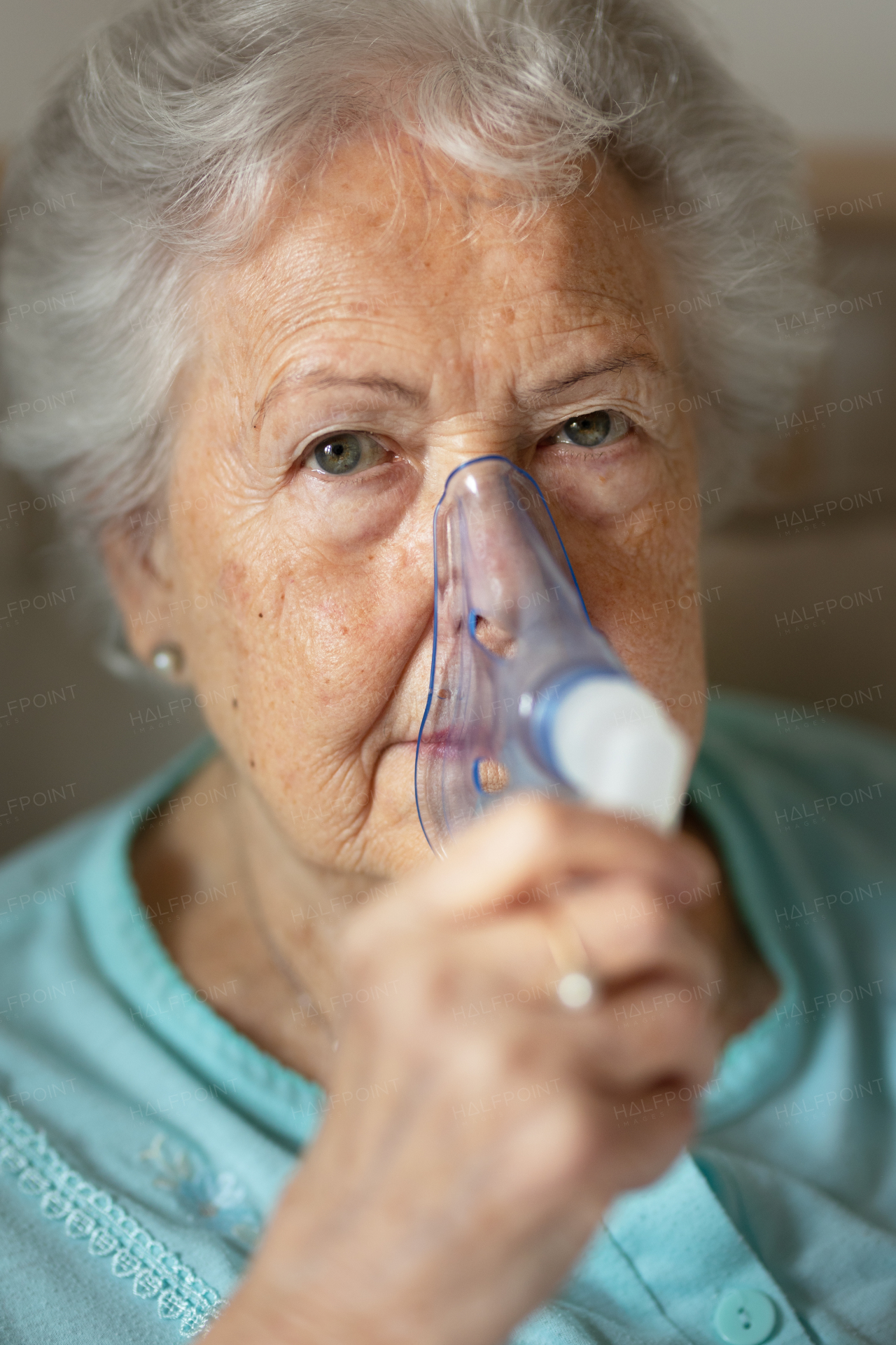 Portrait of a senior woman with inhaller, healthcare concept.