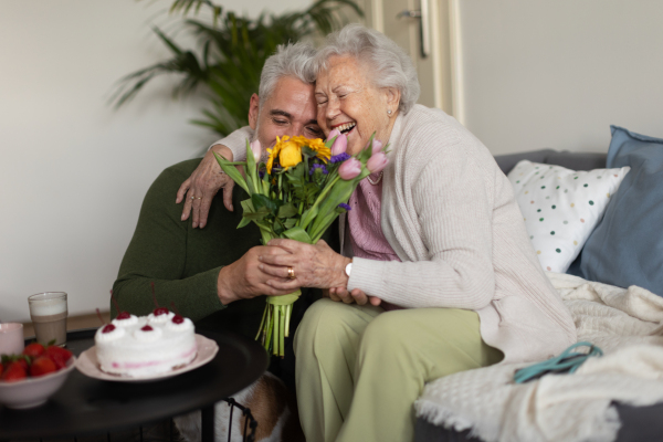 Mature man visiting his senior mother at her home.