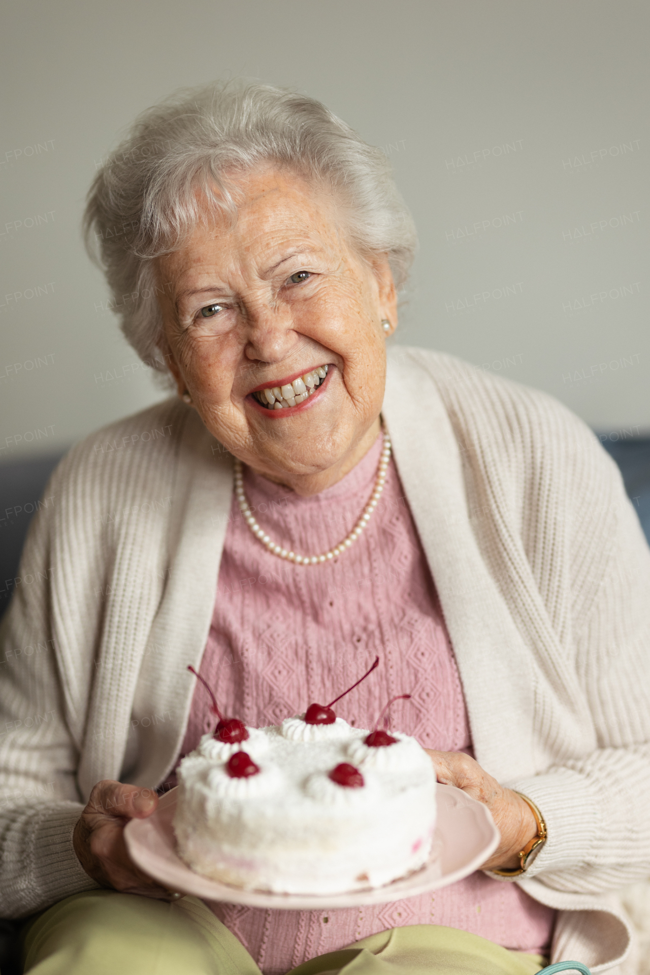 Portrait of senior woman with a birthday cake.