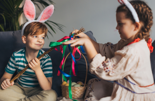 Boy holding handmade whip, made of willow branches, decorated with ribbons. Unique easter custom from slovakia, gently whipping woman and tranditional verses and easter wishes. Concept of Slovakian easter custom.