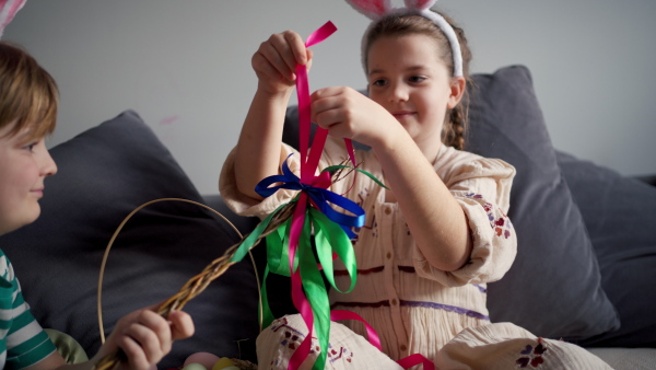 Boy holding handmade whip, made of willow branches, decorated with ribbons. Unique easter custom from slovakia, gently whipping woman and tranditional verses and easter wishes. Concept of Slovakian easter custom.