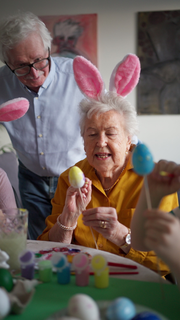 Grandparetns with grandchildren eating traditional easter lunch. Recreating family traditions and customs. Concept of family easter holidays.