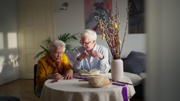 A video of a senior couple praying during an easter holidays. Concept of religious people.