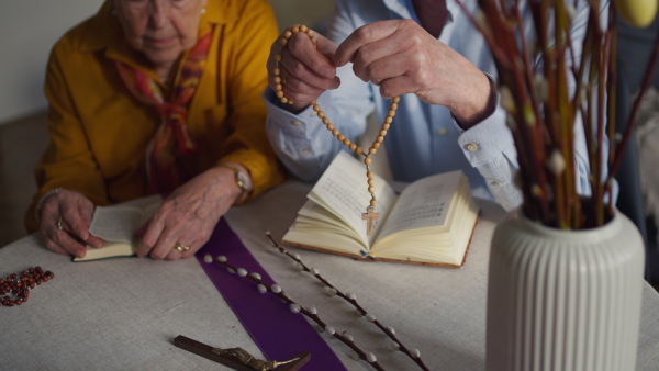 A close up video of a senior couple praying during an easter holidays. Concept of religious people.