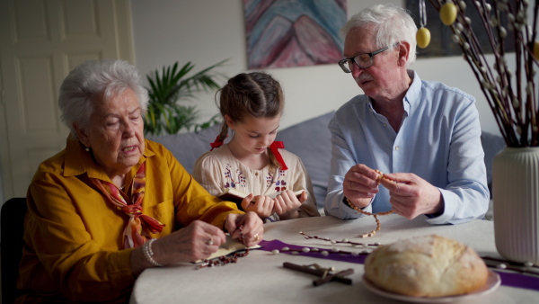 A video of a senior couple praying their granddaughter during an easter holidays. Concept of religious people.