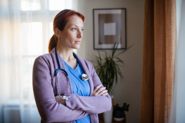 Portrait of young nurse, concept of healthcare in the seniors home.