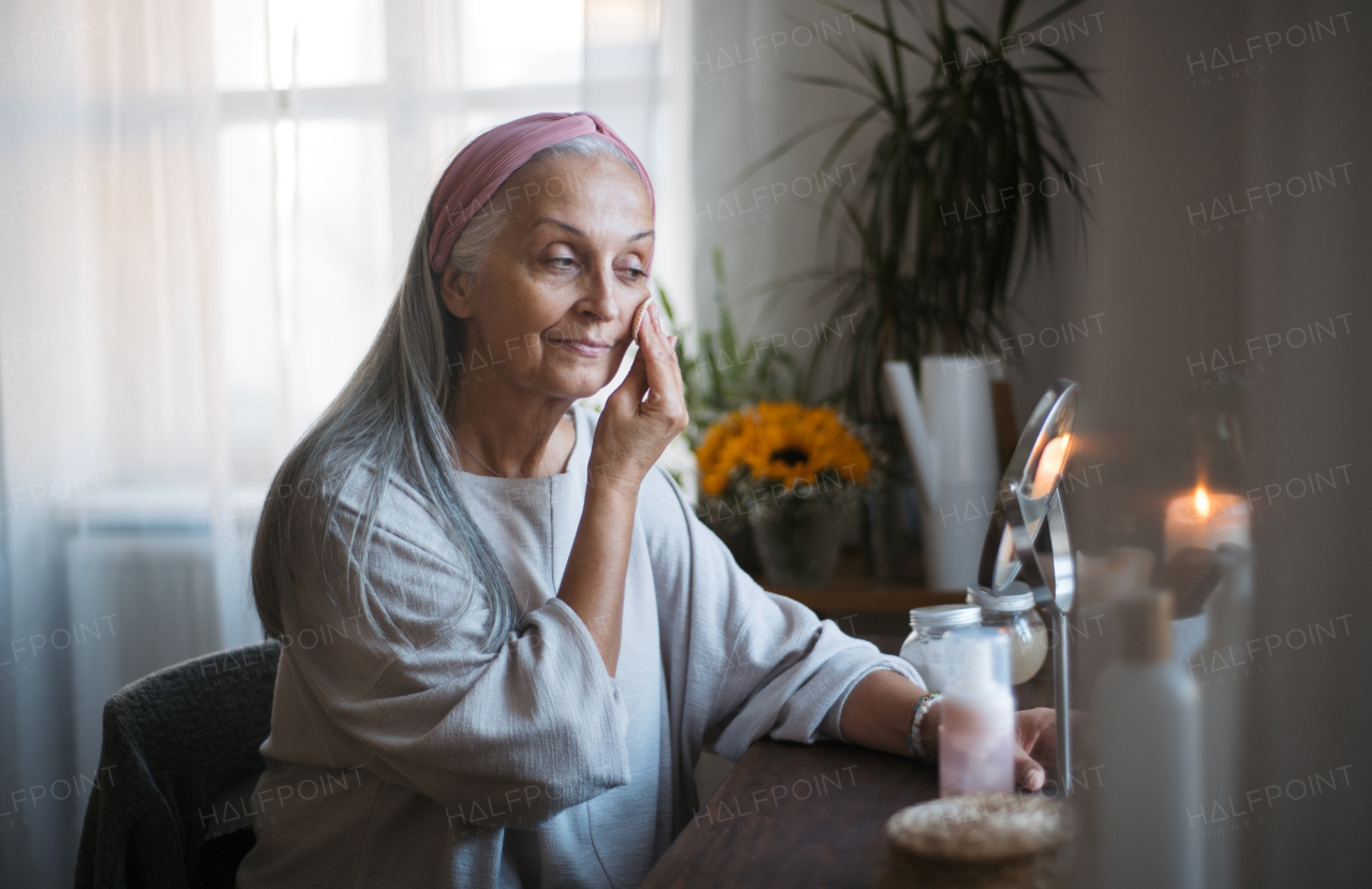 Senior woman making make up herself in home. Skincare routine of beautiful elderly woman.