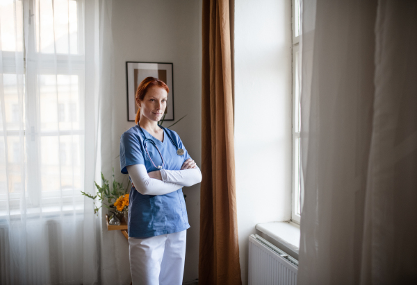 Portrait of young nurse, concept of healthcare in the seniors home.