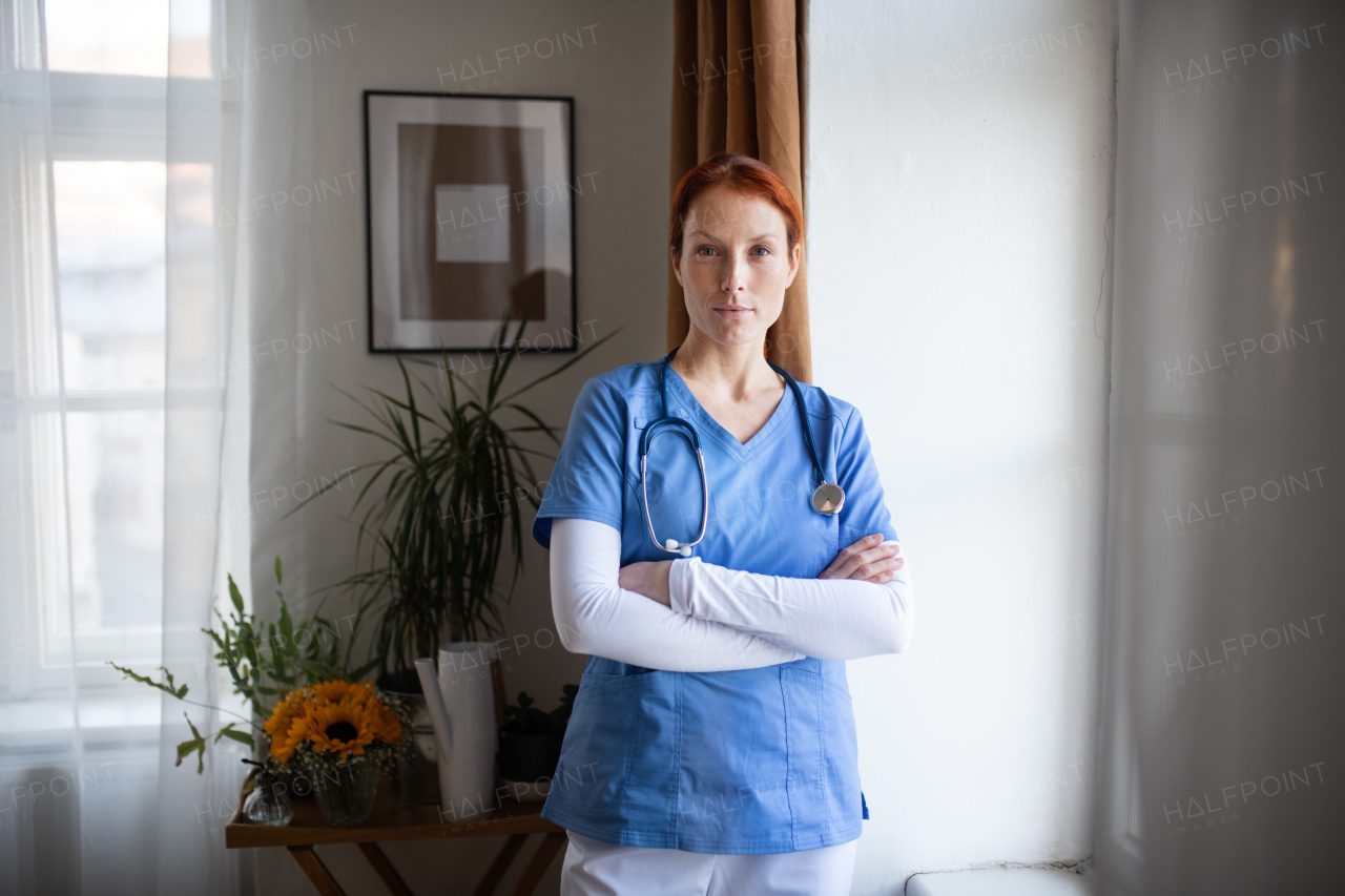 Portrait of young nurse, concept of healthcare in the seniors home. Beautiful female doctor at house call, doctor visiting patient home.