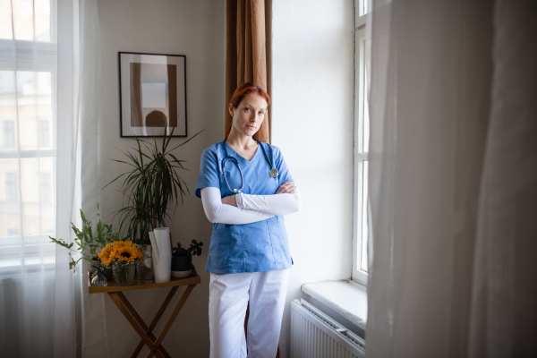 Portrait of young nurse, concept of healthcare in the seniors home.