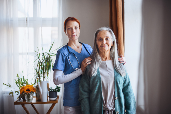 Portrait of senior caregiver and senior woman in her home.