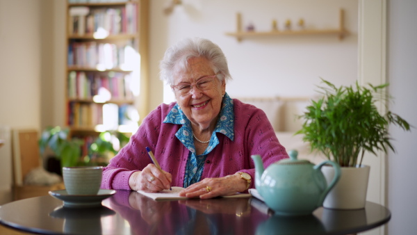 A video of elderly woman solving sudoku puzzles at home, sitting in living room. Sudoku as popular game for aging people, logical thinking, problem solving.