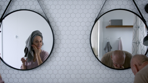 A senior couple in bathroom, washing, having fun, morning routine concept.