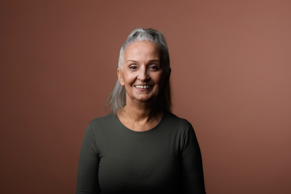 Portrait of smiling senior woman in a studio.