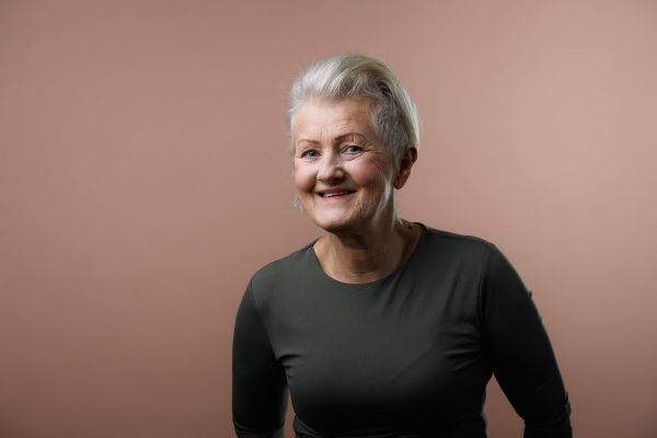 Portrait of smiling senior woman in a studio.