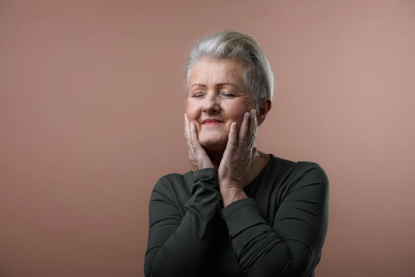 Portrait of smiling senior woman in a studio.